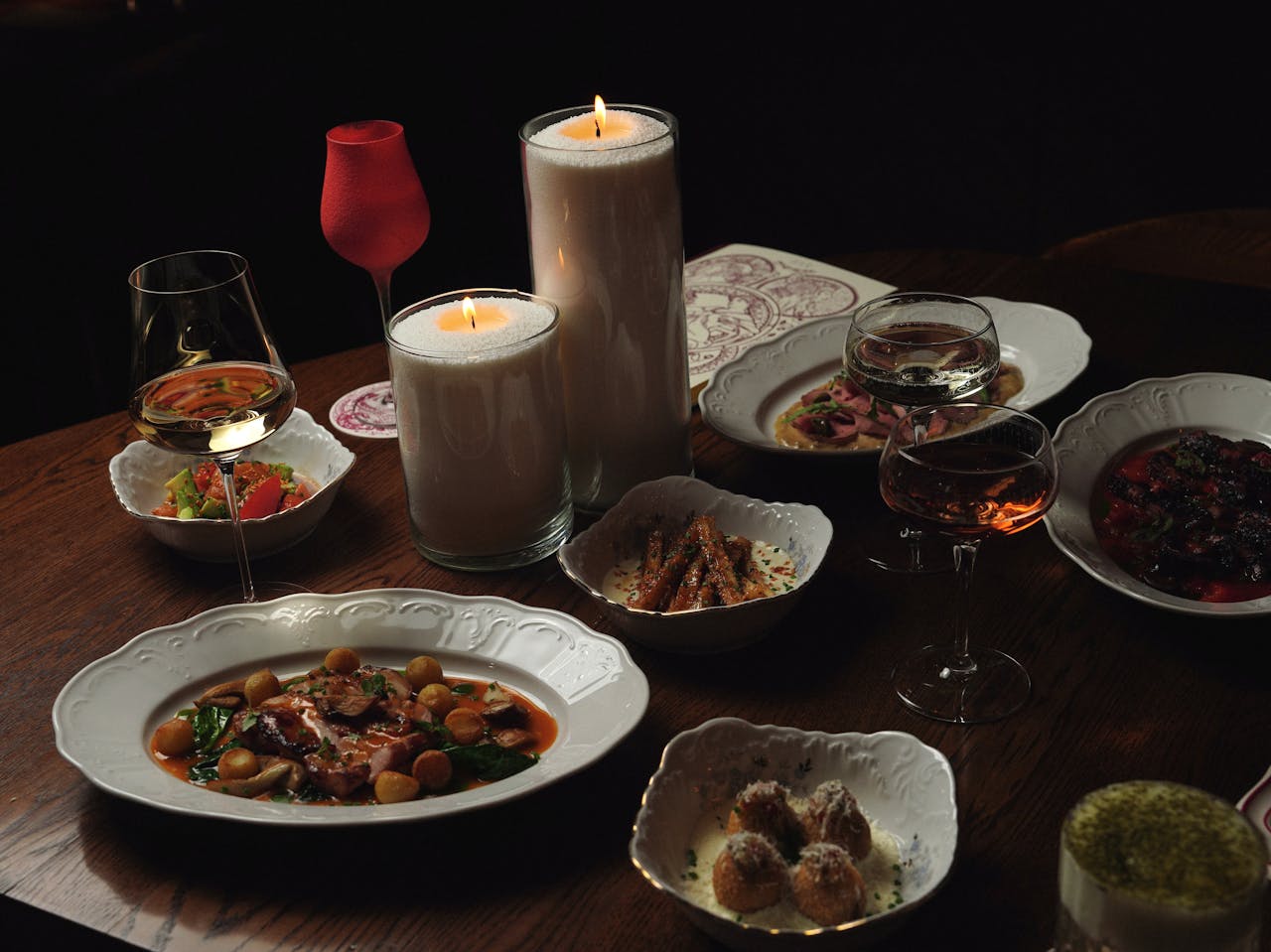 A luxurious dining table setup with gourmet dishes and candlelight mood.