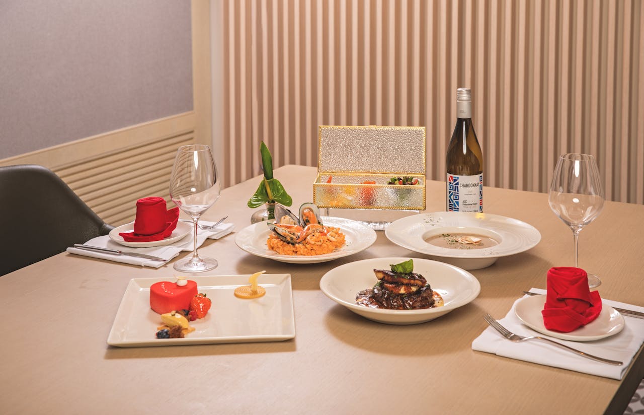 Mastering the First Impression: Your intriguing post title goes here Luxurious dining setup with gourmet seafood, wine, and desserts on an elegantly dressed table.